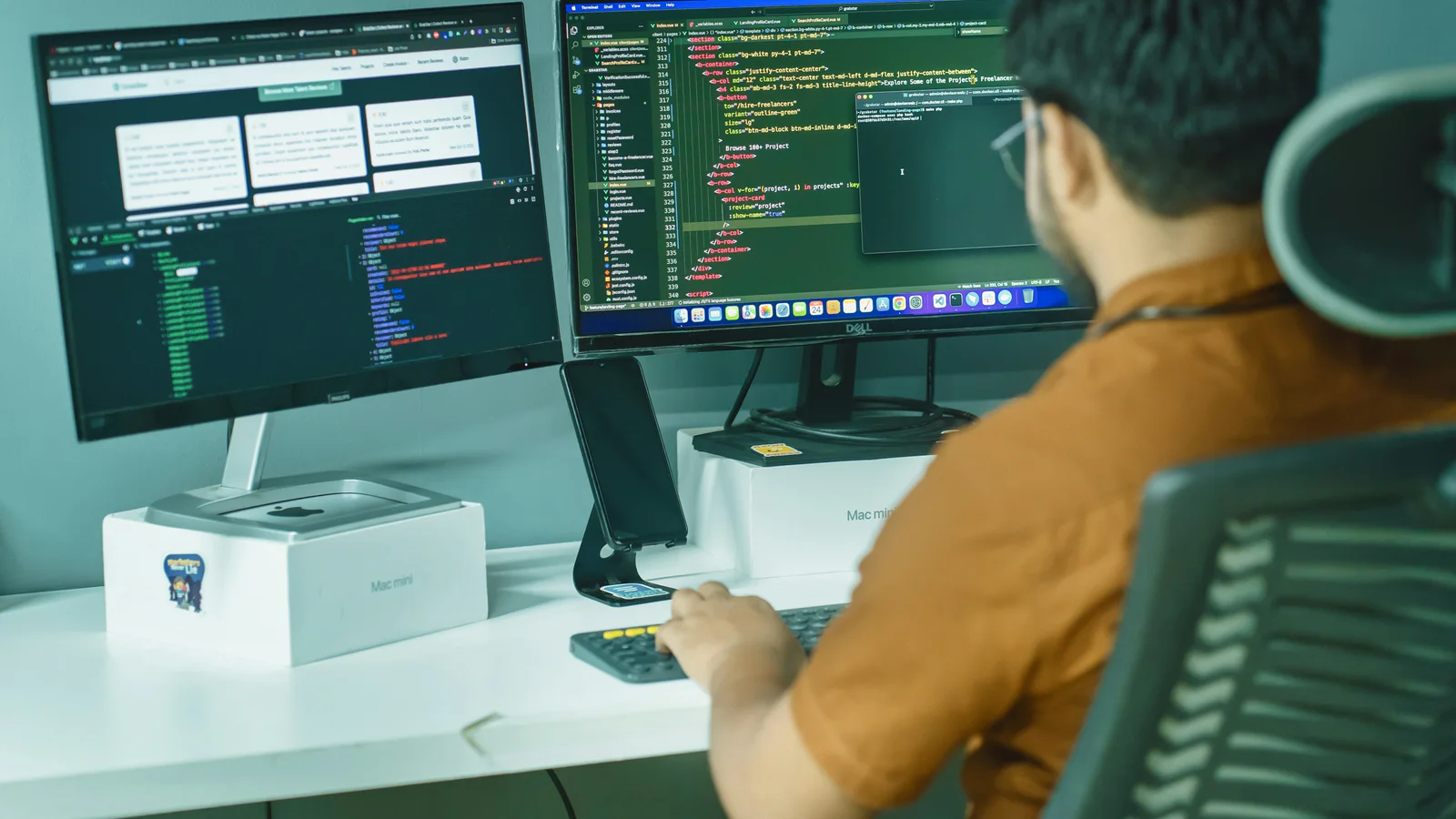Developer working at a dual-monitor programming workstation